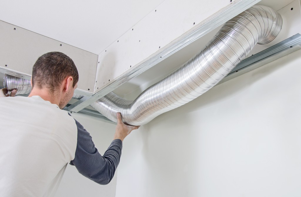Man setting up the ventilation system