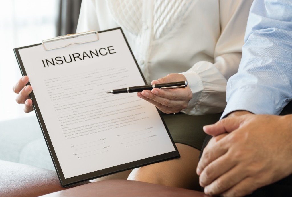 woman holding an insurance contract