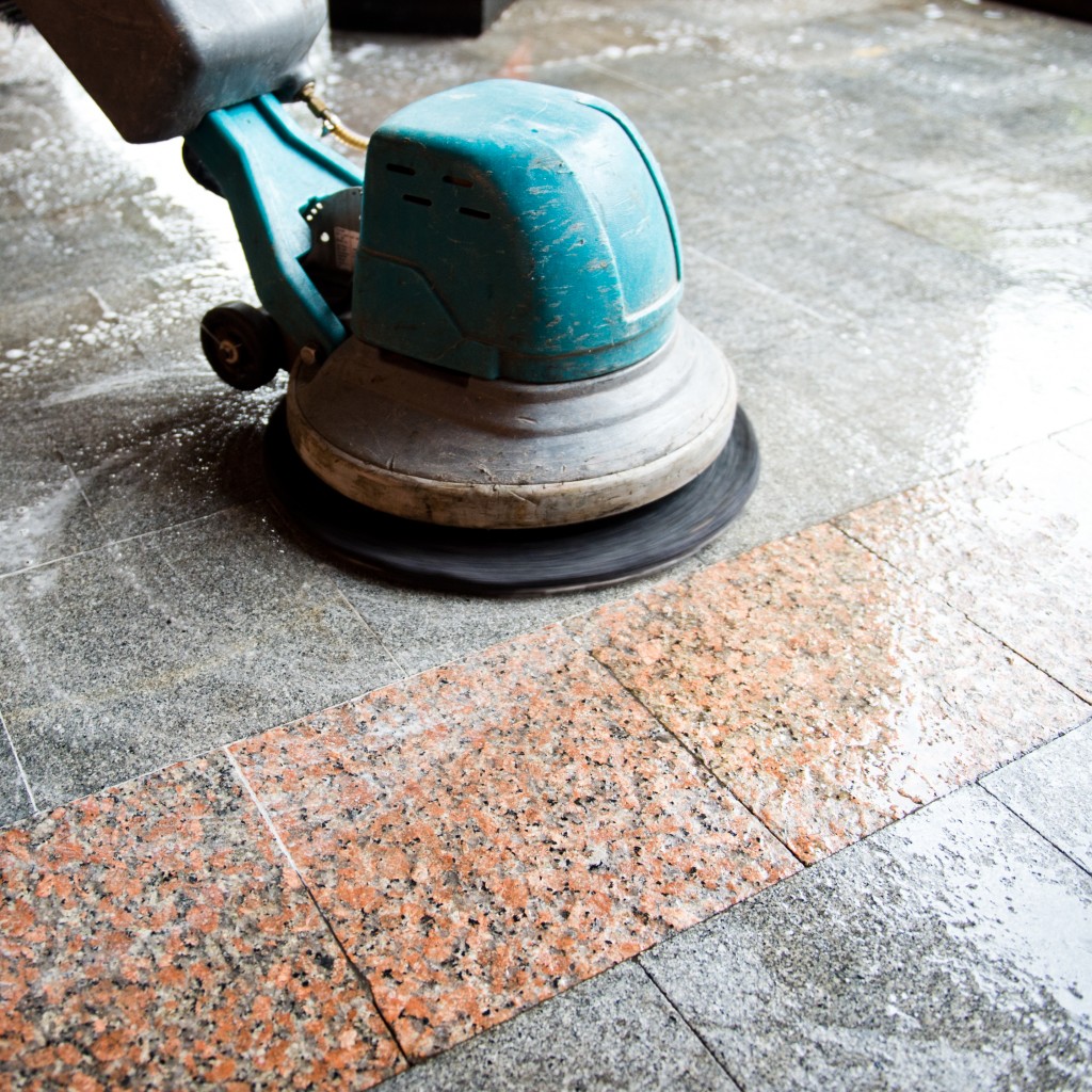 Floor scrubber cleaning tiles