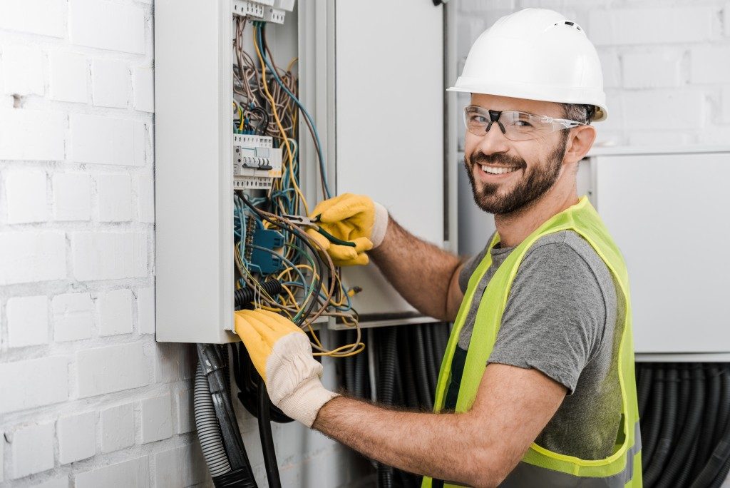 man fixing electrical fuses