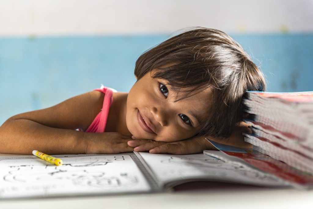 little girl smiling while studying