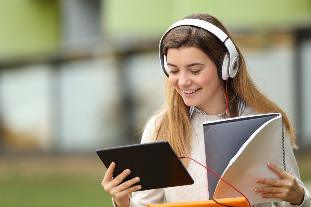 Woman using her tablet and headphones