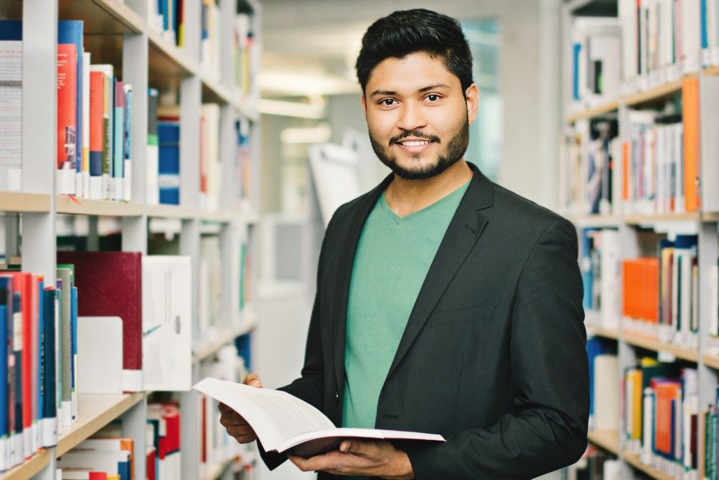 Male Indian student in the library