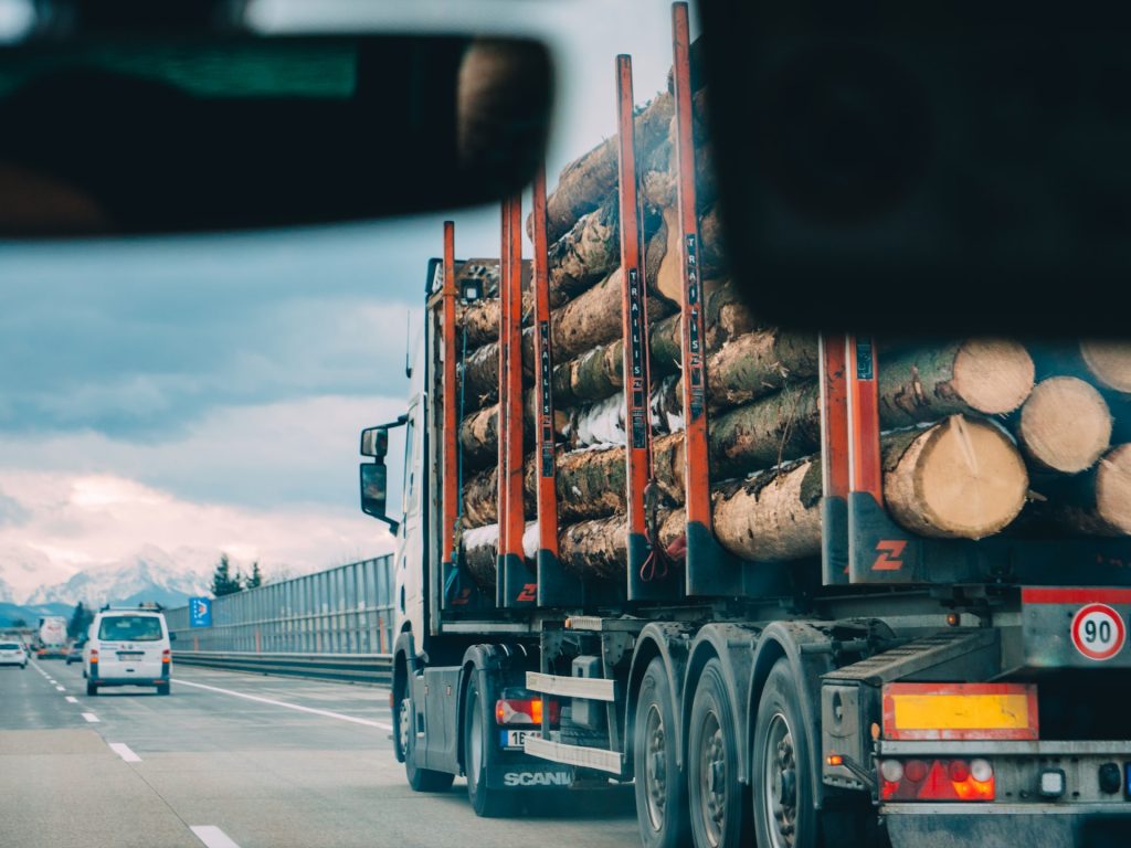 truck on the road loaded with wood basic industry