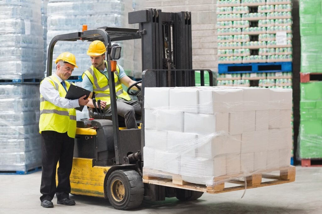 forklift driver talking to a manager