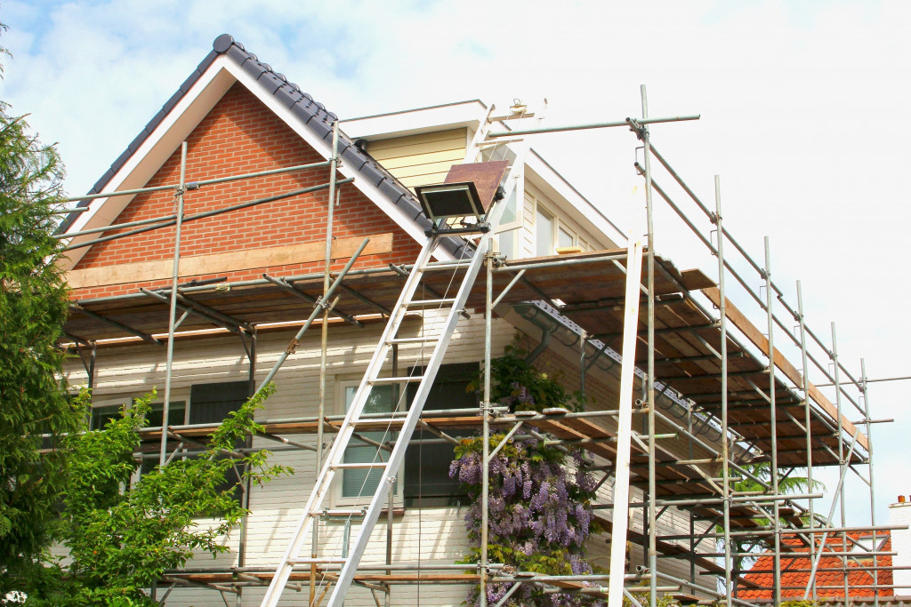 old home under renovation with ladders and frames
